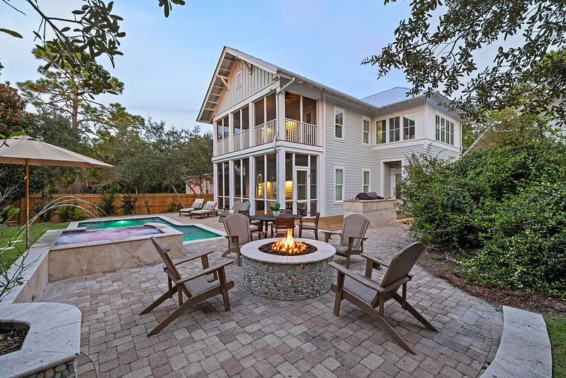 Listing-ready Florida vacation home exterior with outdoor living at dusk for remote investor walkthrough